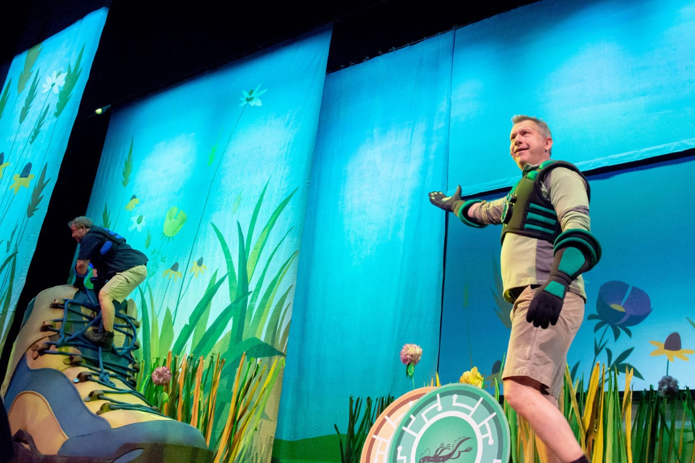martin kratt climbing into a giant boot during wild kratts live